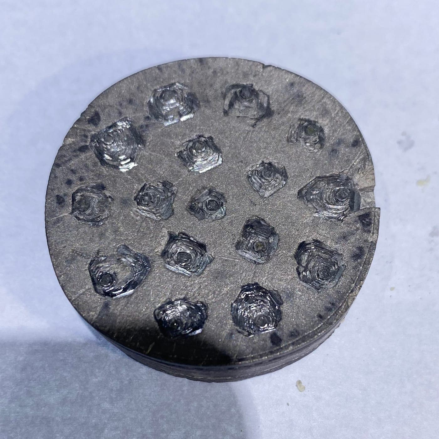 A chemical vapor deposition growth plate, rough diamond crystals raised on their seed pads